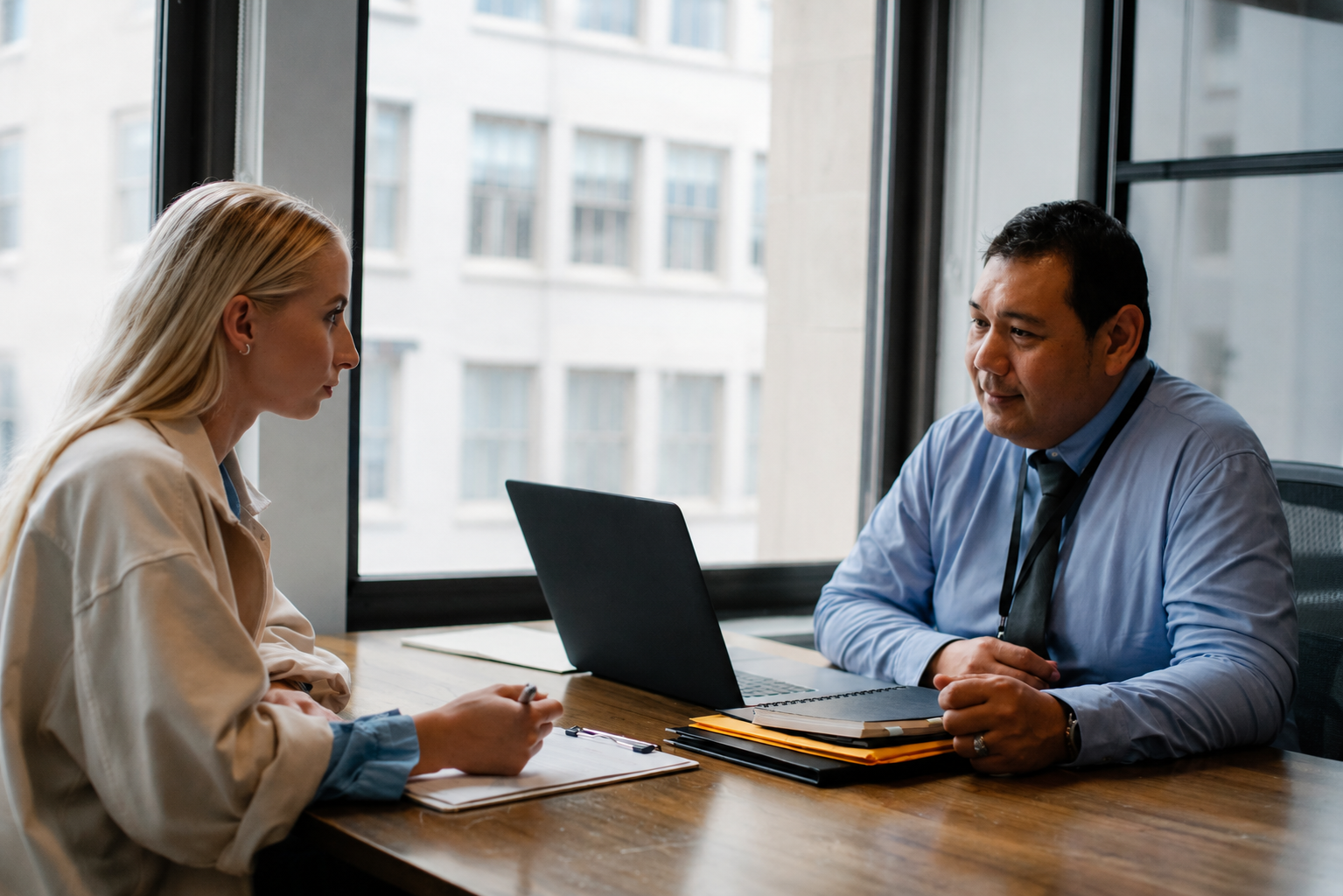 Professional job candidate meeting with a hiring manager during a one-on-one interview in a modern office, demonstrating effective communication, confidence, and preparation to stand out in a competitive job market.